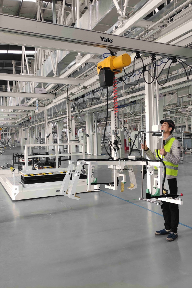 Ergonomic overhead rail lifting system for automotive chassis and doors.