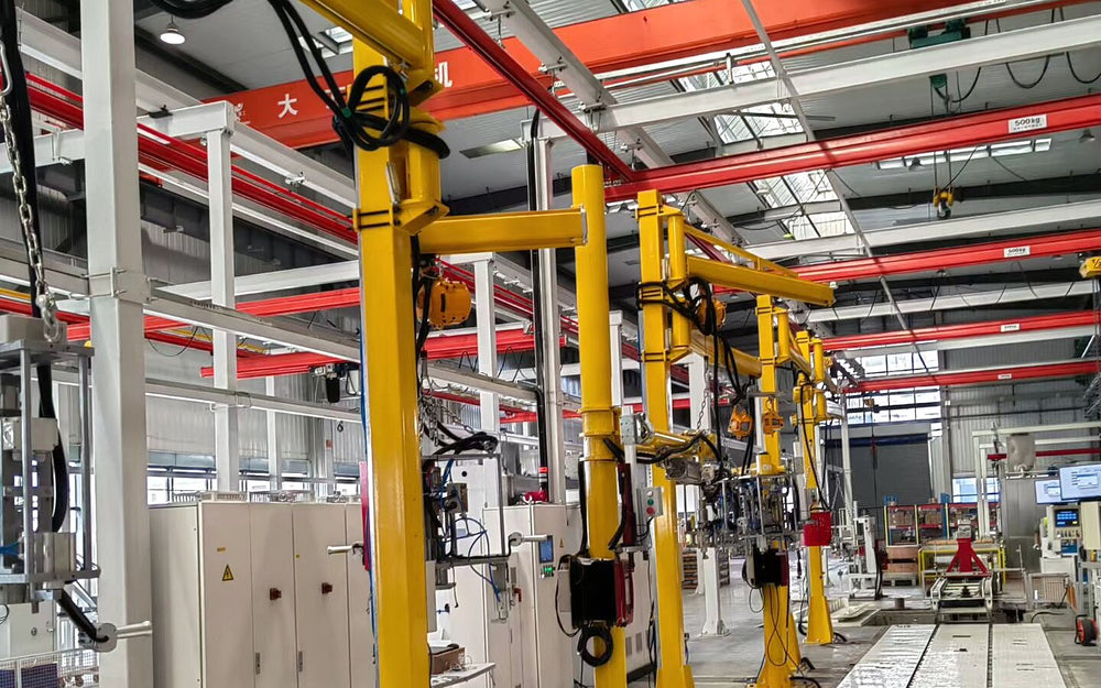 Row of yellow industrial manipulators installed on a production line